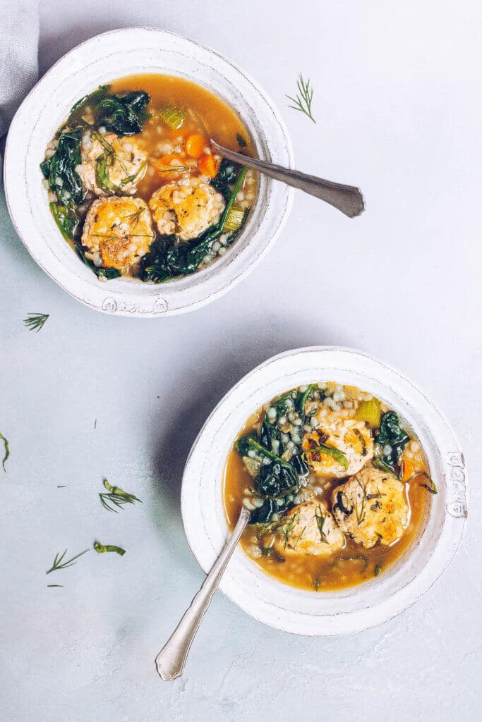 Chicken Florentine Bone Broth Soup in 2 bowls with fresh herbs