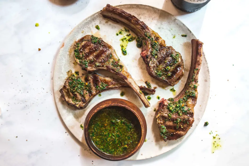 grilled baby lamb chops with chimichurri on a plate