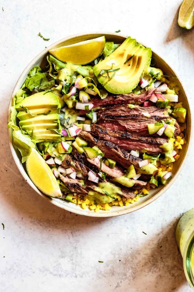 This Paleo Carne Asada Bowl recipe is perfect for summer and meal-prep! It's light, yet filling, and packed with fresh flavors.