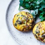 egg muffins with ground meat and veggies on a plate with salad