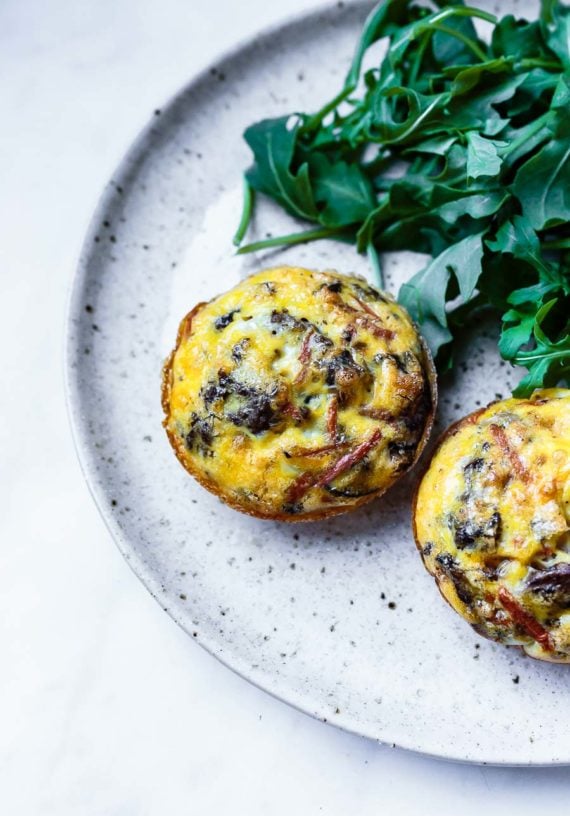 egg muffins with ground meat and veggies on a plate with salad