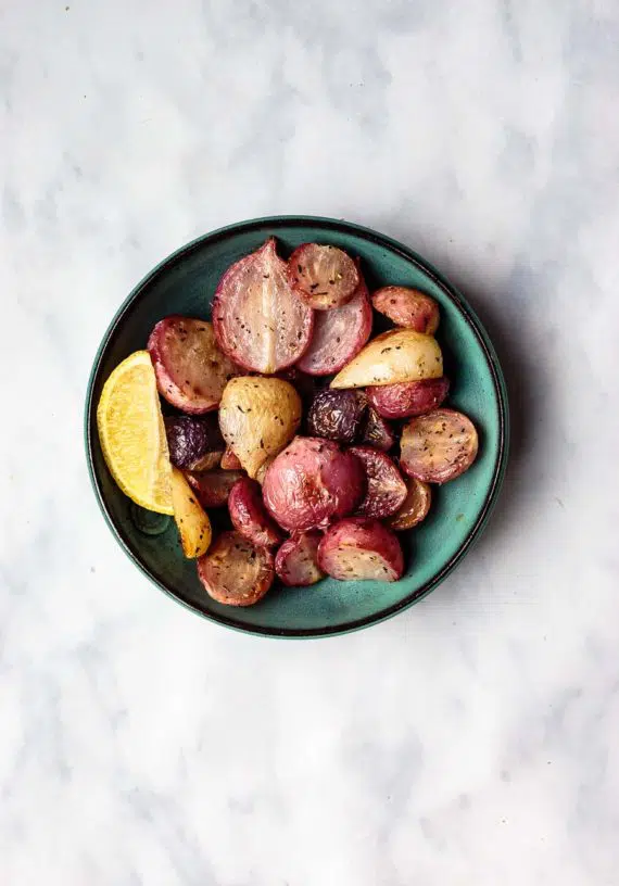roasted radishes in a bowl with lemon