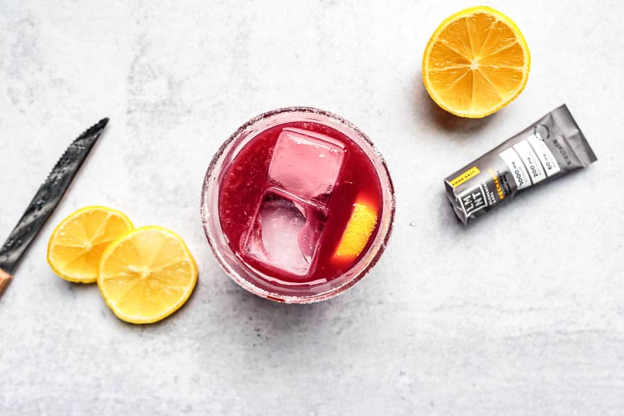 pomegranate punch mocktail with lemon slices and electrolytes