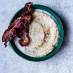 overhead shot of parsnip porridge in a circular bowl with a side of bacon