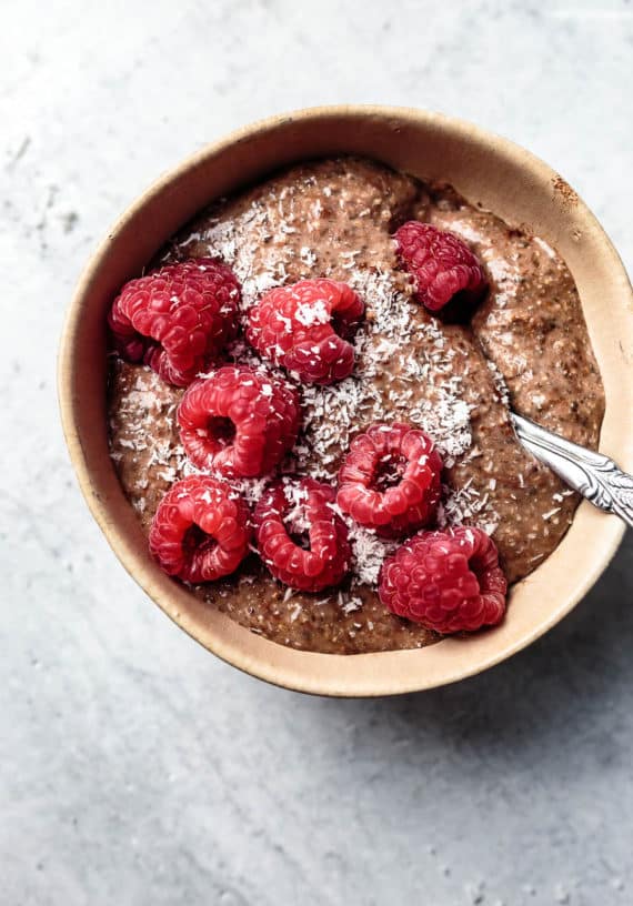 blended chocolate chia pudding with raspberries in a bowl